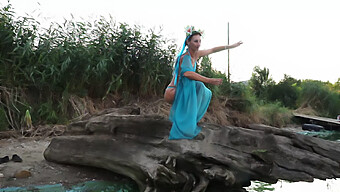 Young Woman Dances In The Sand In Public